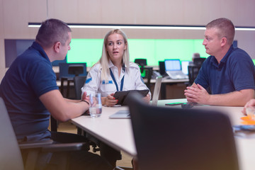 Security guard monitoring modern CCTV cameras in a surveillance room. Group of security guards sitting and monitoring.