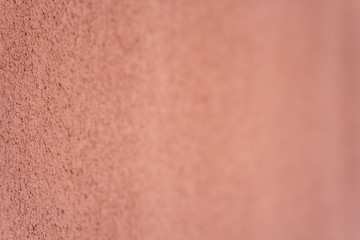 Empty background. Orange wall, porous texture. Soft focus.