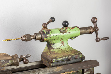 Drill chuck in tailstock on the lathe. The tailstock is green from an old lathe.