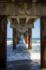 Calm ocean water view under pier