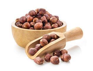 hazelnuts in wood bowl and scoop  on white background
