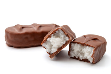 Chocolate covered sweets and  candy bar concept coconut filling bars isolated on white background