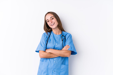 Young nurse woman isolated laughing and having fun.