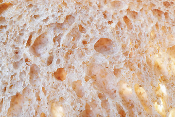 Close up macro of crumb of fresh tasty sourdough bread. Horizontal shot. Bread business concept.