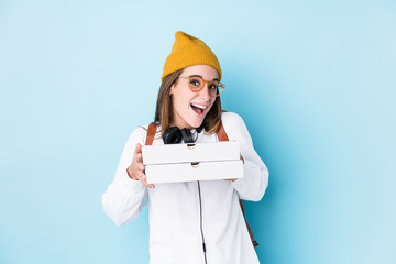 Young caucasian student woman holding pizzas