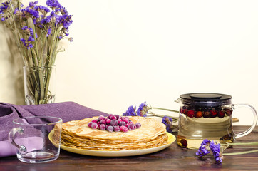 Maslenitsa. Russian folk festival, traditions. stack of homemade thin pancakes with cranberries and...