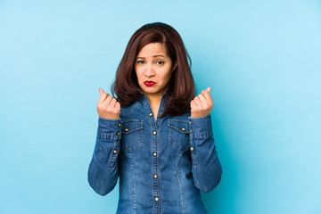 Middle age latin woman isolated on a blue background showing that she has no money.