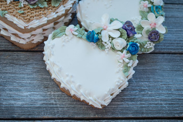 Heart shaped cookies decorated with royal icing glaze and flowers