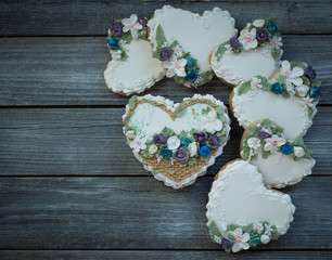 Obraz na płótnie Canvas Heart shaped cookies decorated with royal icing glaze and flowers