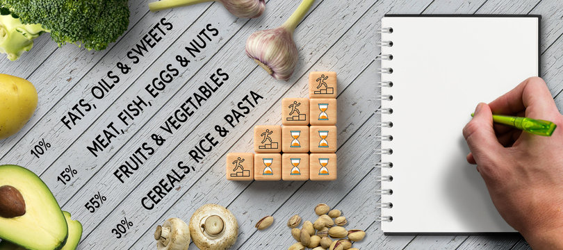 many cooking ingredients and a healthy plan on wooden background