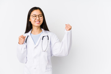 Young doctor chinese woman isolated raising fist after a victory, winner concept.