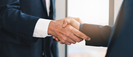 business background of businessman having handshaking after finish business deal