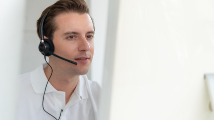 business background of caucasian male customer service agent on telephone service to customers at helpdesk call center - obrazy, fototapety, plakaty
