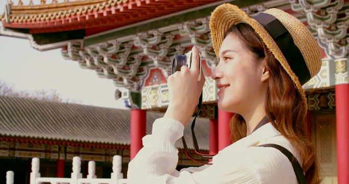 asian female traveler photographing temples at  Asia 