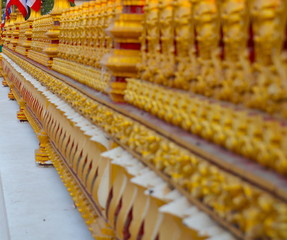 Wat Nong Wang in Khon Kaen Essan Thailand a temple with 9 golden levels and Payanak surrounding the exterior