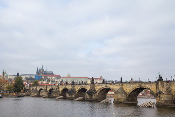 Fototapeta na wymiar Panorama of the Old Town of Prague, Czech Republic, with a focus on Charles bridge (Karluv Most) and the Prague Castle (Prazsky hrad) seen from the Vltava river. 