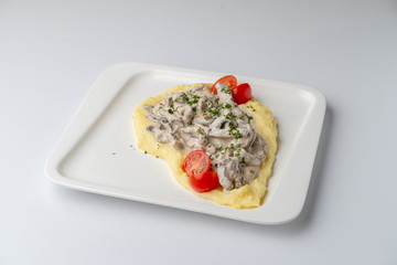Comfort food: potato puree with mushroom gravy isolated on white background