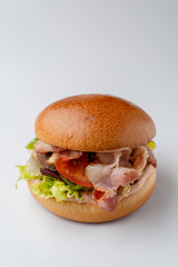 Juicy burger with crispy bacon isolated on white background