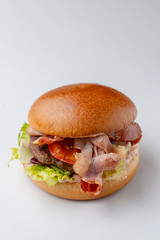 Juicy burger with crispy bacon isolated on white background