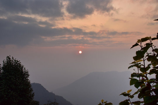 Golden sunrise in the panoramic mountain landscapes of Himalayan range from Takdah, Darjeeling, India