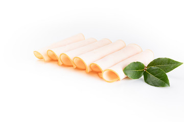 Poultry cold cuts cut into slices, rolled, isolated on white background, top view.