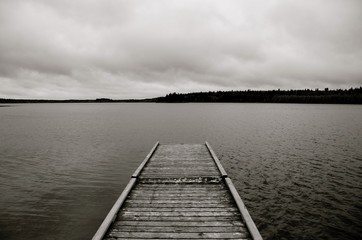 old wooden pier on the lake in black and white - Laurie lake - duck mountain provincial park - Manitoba