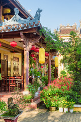 Fototapeta na wymiar Scenic cafe in beautiful garden of Phap Bao Temple, Hoian
