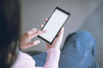 Woman using smart phone while working in the coffeeshop. Modern and smart lifestyle with online mobile technology.
