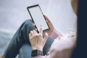 Woman using smart phone while working in the coffeeshop. Modern and smart lifestyle with online mobile technology.