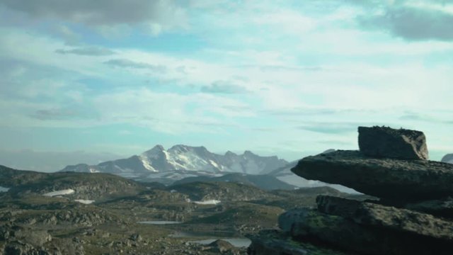 Sliding past a cairn to reveal sognefjellet mountain range in jotunheimen, norway