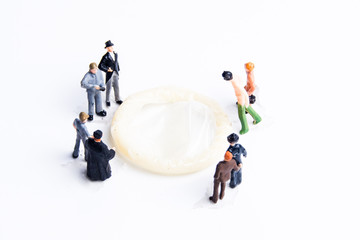 Macro photography of men surrounding condom on family planning concept.