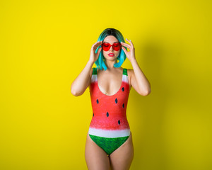 Portrait of a woman in a swimsuit with a picture of a watermelon. Stylish girl in a colored short...