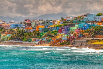 Colorful houses line the hillside over looking the beach in San Juan, Puerto Rico