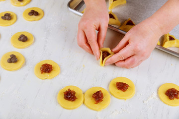 Preparing hamantaschen cookies for Purim. Jewish holiday concept,