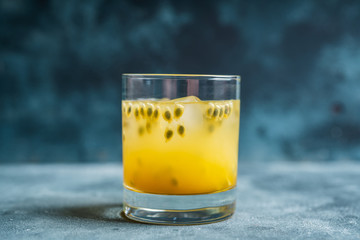 Old fahioned passion fruit cocktail on the rustic background. Selective focus. Shallow depth of field.