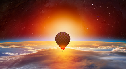 Hot air balloon on the foreground Planet Earth with a spectacular sunset 