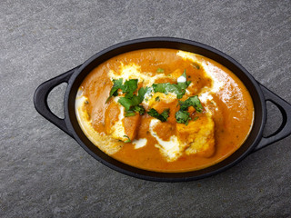 Top down view of Paneer Butter Masala , a rich and creamy Indian dish made of Paneer or Tofu in tomato and cream gravy.