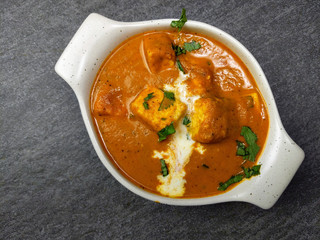 Top down view of Paneer Butter Masala , a rich and creamy Indian dish made of Paneer or Tofu in tomato and cream gravy.