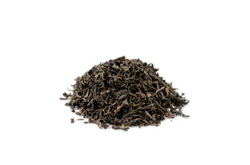 Pile of dry black tea leaves on a white background close-up.