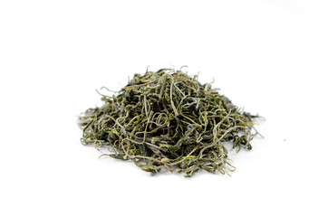 Pile of dry green tea leaves on a white background close-up.