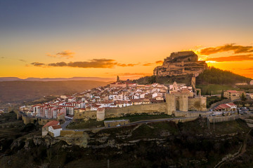 Obraz premium Aerial sunset view of Morella castle and town in central Spain with surrounding medieval walls, towers and winter festival