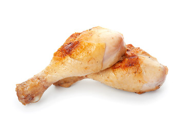 Cooked chicken drumsticks on white background