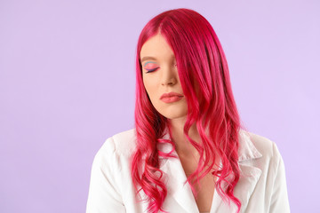 Beautiful young woman with unusual hair on color background