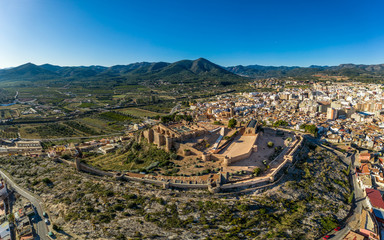 Aerial view of medieval Onda partially restored medieval castle ruin in Spain with concentric walls, semi circular towers, inner and outer bailey