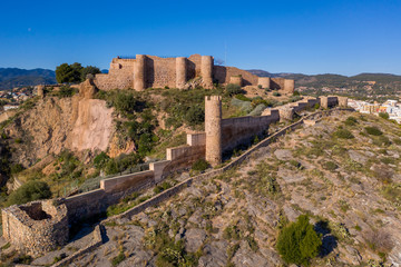 Aerial view of medieval Onda partially restored medieval castle ruin in Spain with concentric walls, semi circular towers, inner and outer bailey