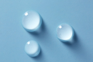 Drops of water on color background