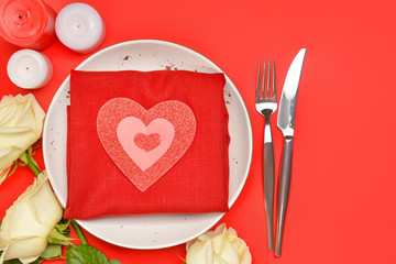 Beautiful table setting for Valentine's Day on red background