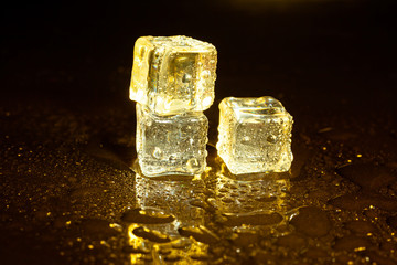 ice cubes on a reflections yellow light.