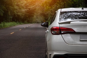 Car on road in forest in summer 