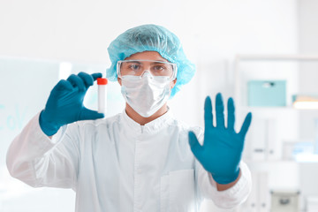 Fototapeta premium Scientist with sample in test tube in laboratory. Concept of epidemic
